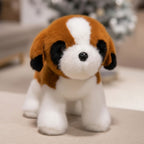 Two soft plush dog toys, one brown and white St. Bernard style, the other brown and white Shiba Inu style, held by a person.