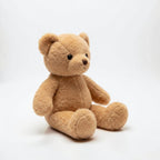 wllio.com brown teddy bear plush toy with soft fur and black button eyes, sitting on a rug in a nursery.